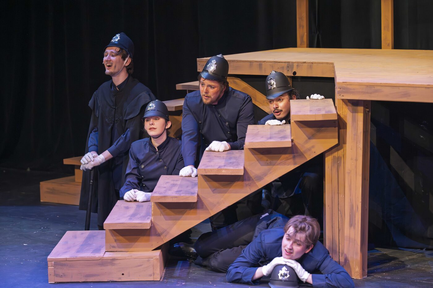 Five police peeking from the staircase