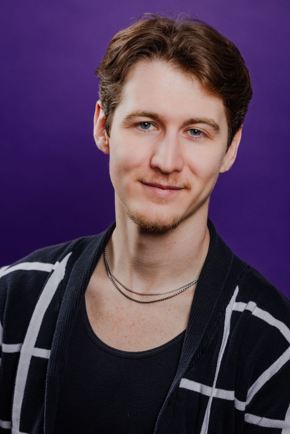 Anthony Edward, headshot — black plaid on purple background